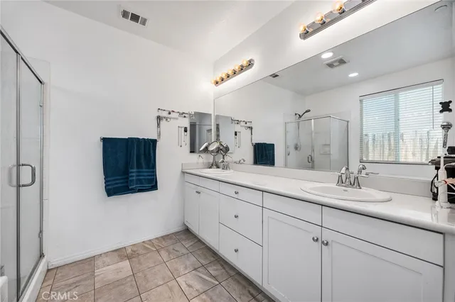 a spacious bathroom with a double vanity sink mirror and