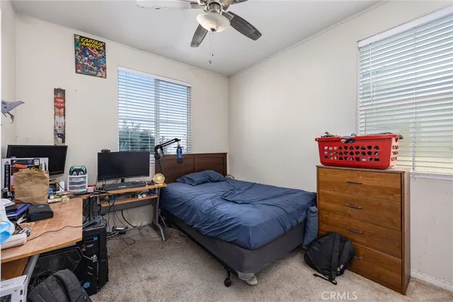 a bedroom with a bed and a desk