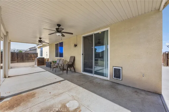 a view of a livingroom with furniture and a ceiling fan