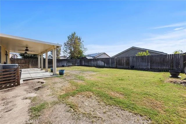 a view of a house with backyard and pool