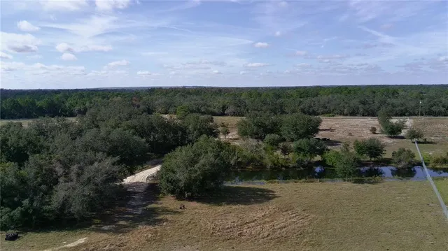 a view of a lake with houses in back
