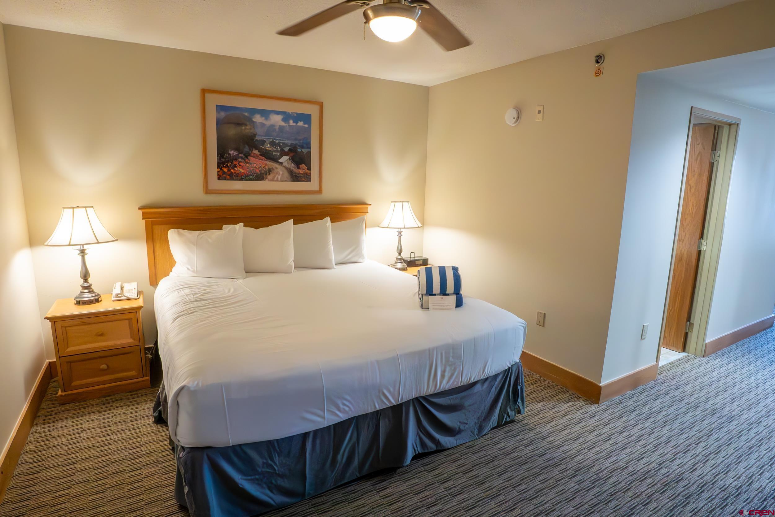 6 Emmons Road, Unit 474 Crested Butte, CO 81225 - Photo 12 of 22 a bedroom with a bed and wooden floor