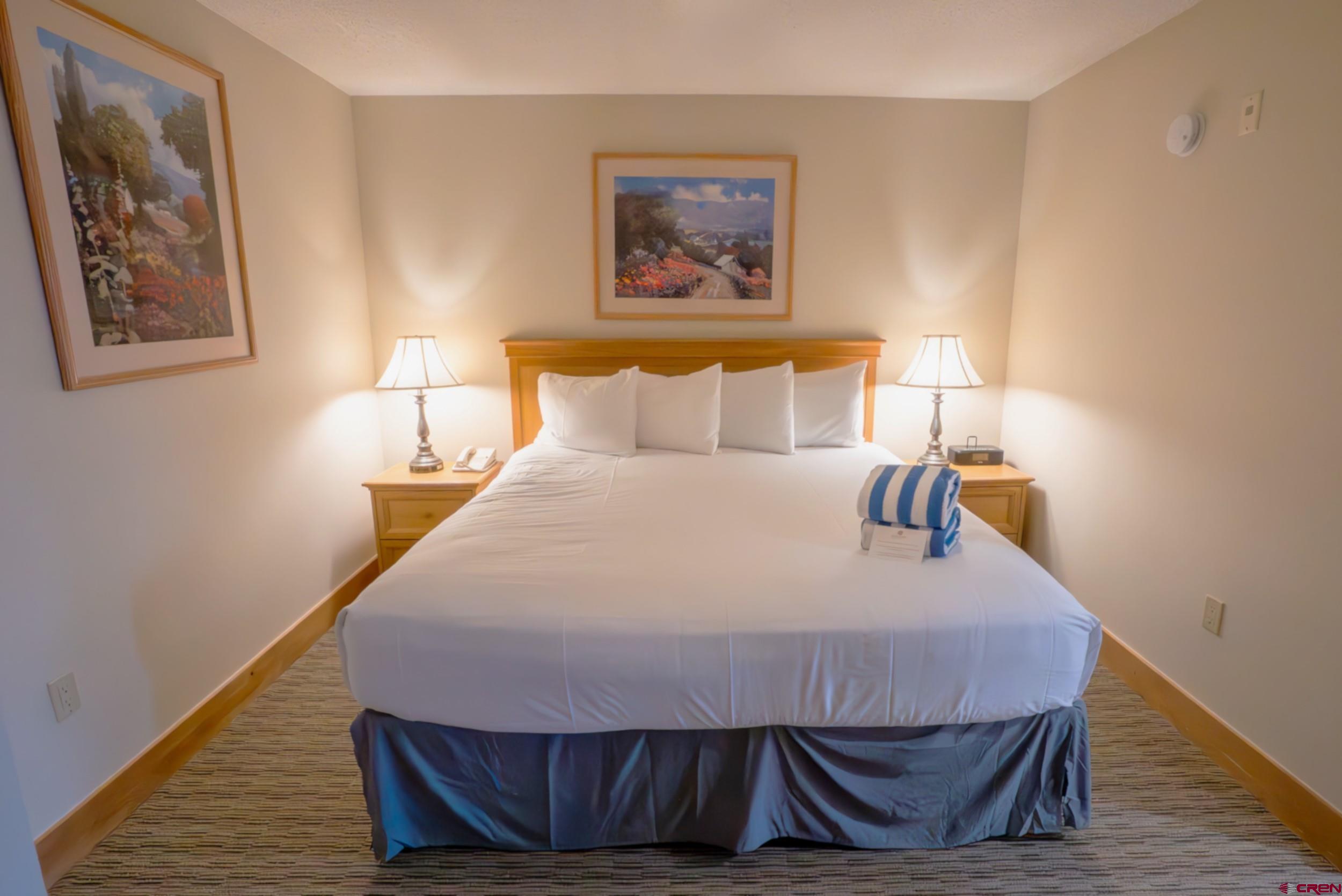 6 Emmons Road, Unit 474 Crested Butte, CO 81225 - Photo 13 of 22 a bedroom with a bed and wooden floor