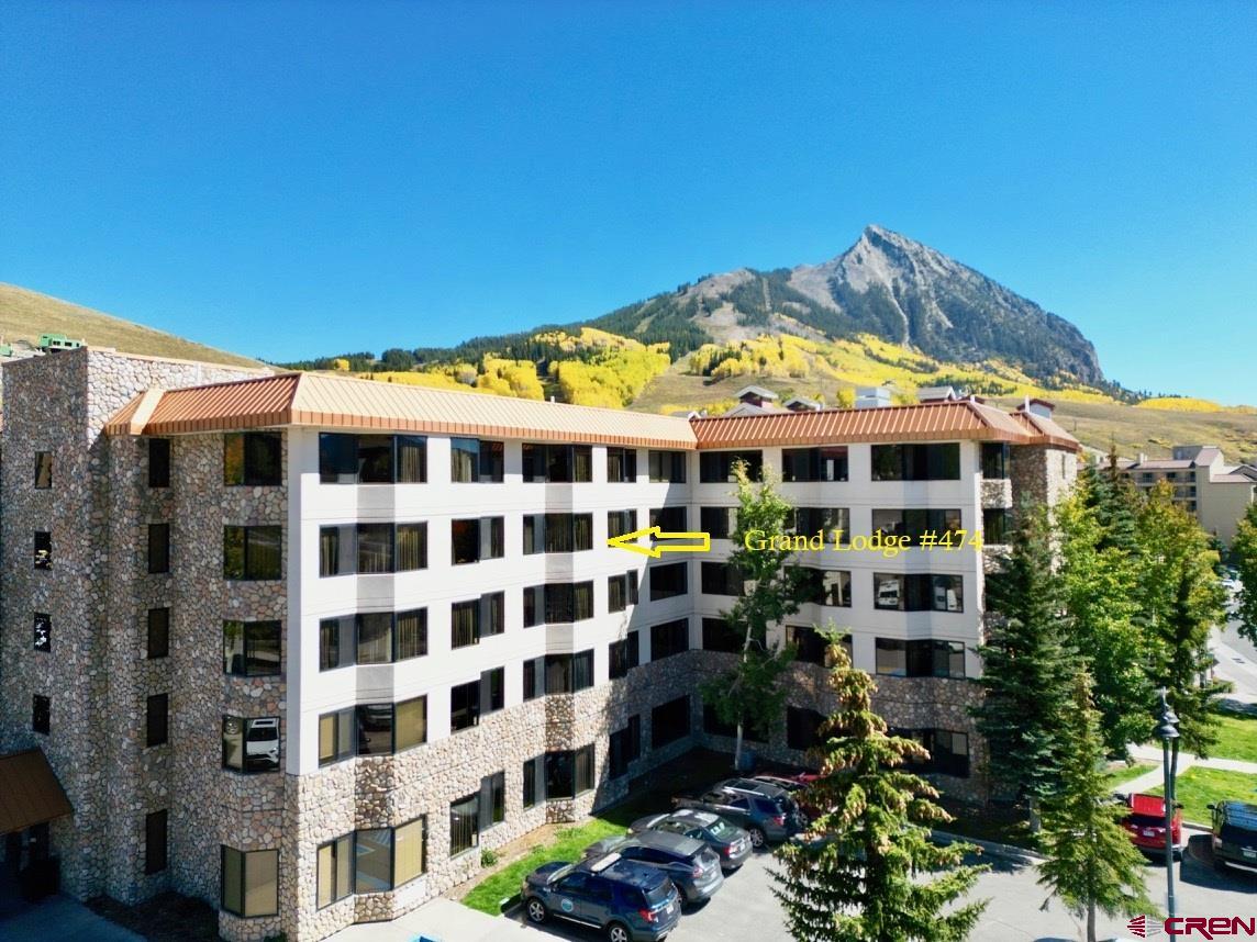 6 Emmons Road, Unit 474 Crested Butte, CO 81225 - Photo 2 of 22 a view of a blue building with a flower garden