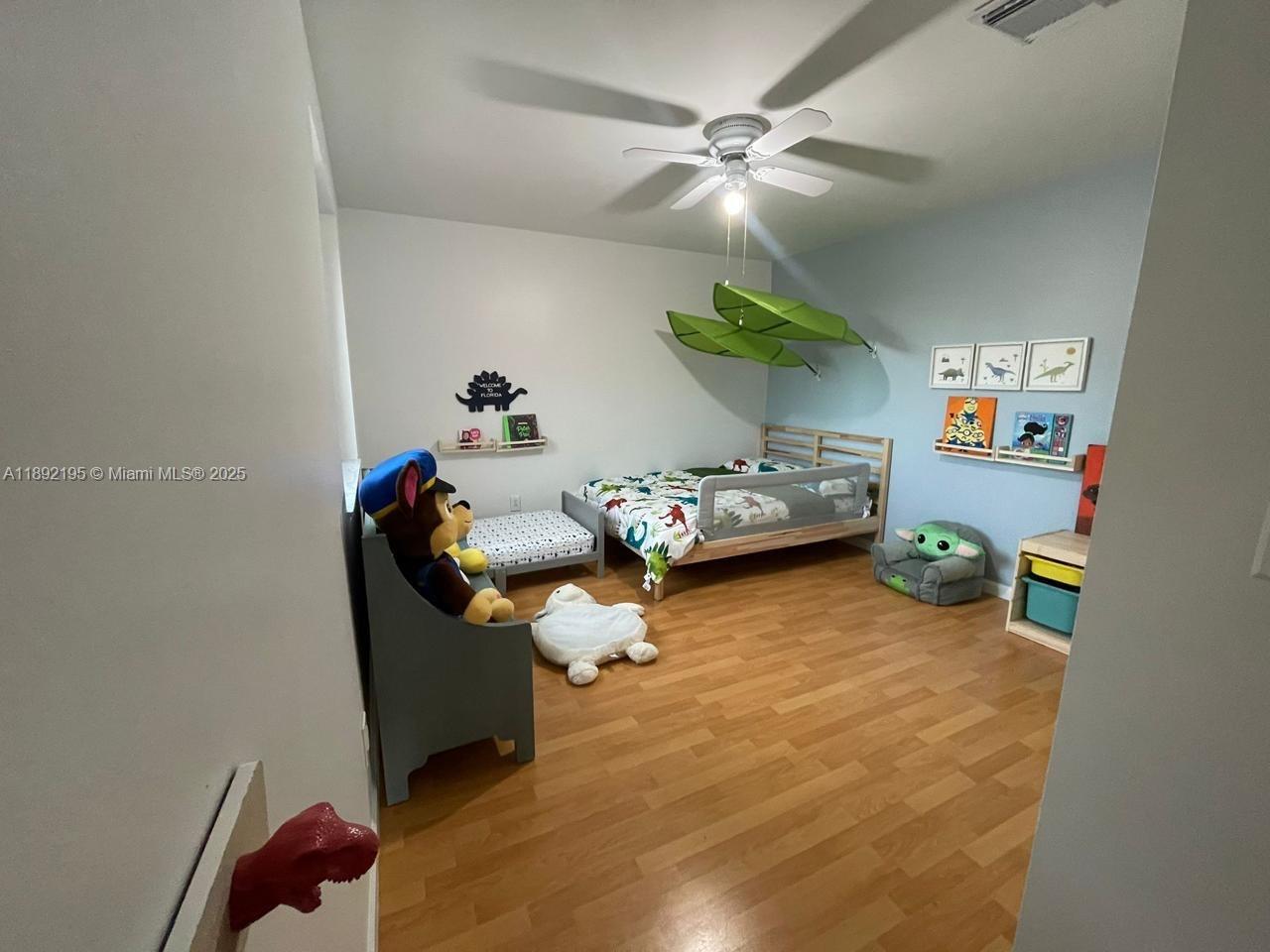 10470 Southwest 16th Street Pembroke Pines, FL 33025 - Photo 11 of 26 a bedroom with furniture and a fan