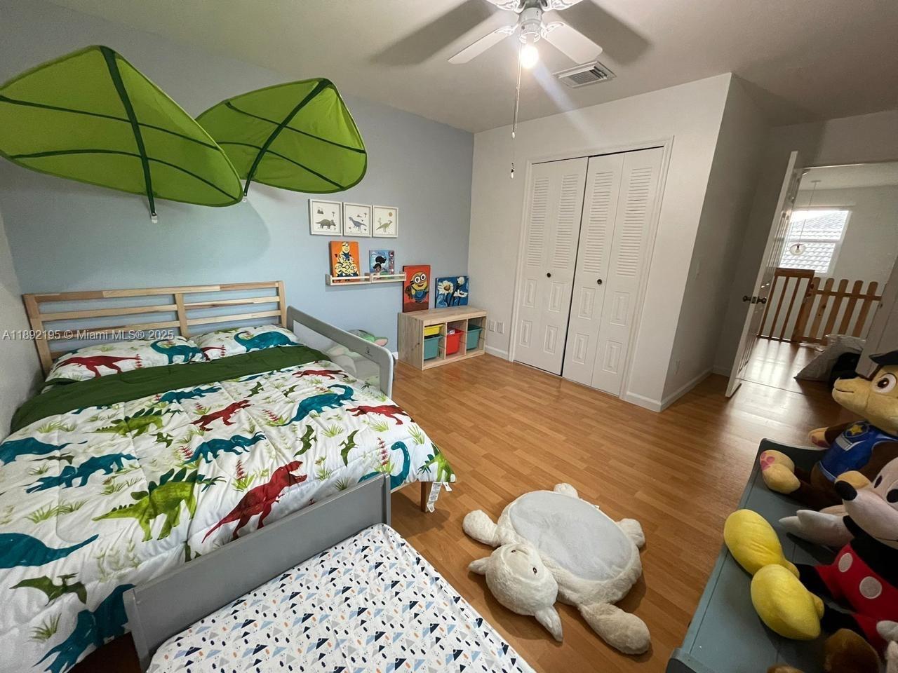 10470 Southwest 16th Street Pembroke Pines, FL 33025 - Photo 15 of 26 a bedroom with a bed and a chandelier