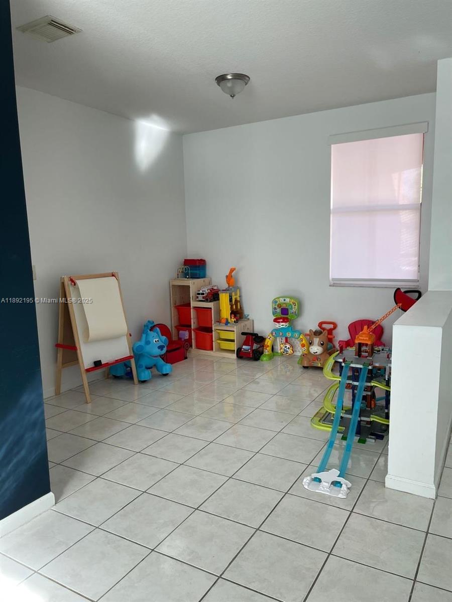 10470 Southwest 16th Street Pembroke Pines, FL 33025 - Photo 18 of 26 a play room with toys