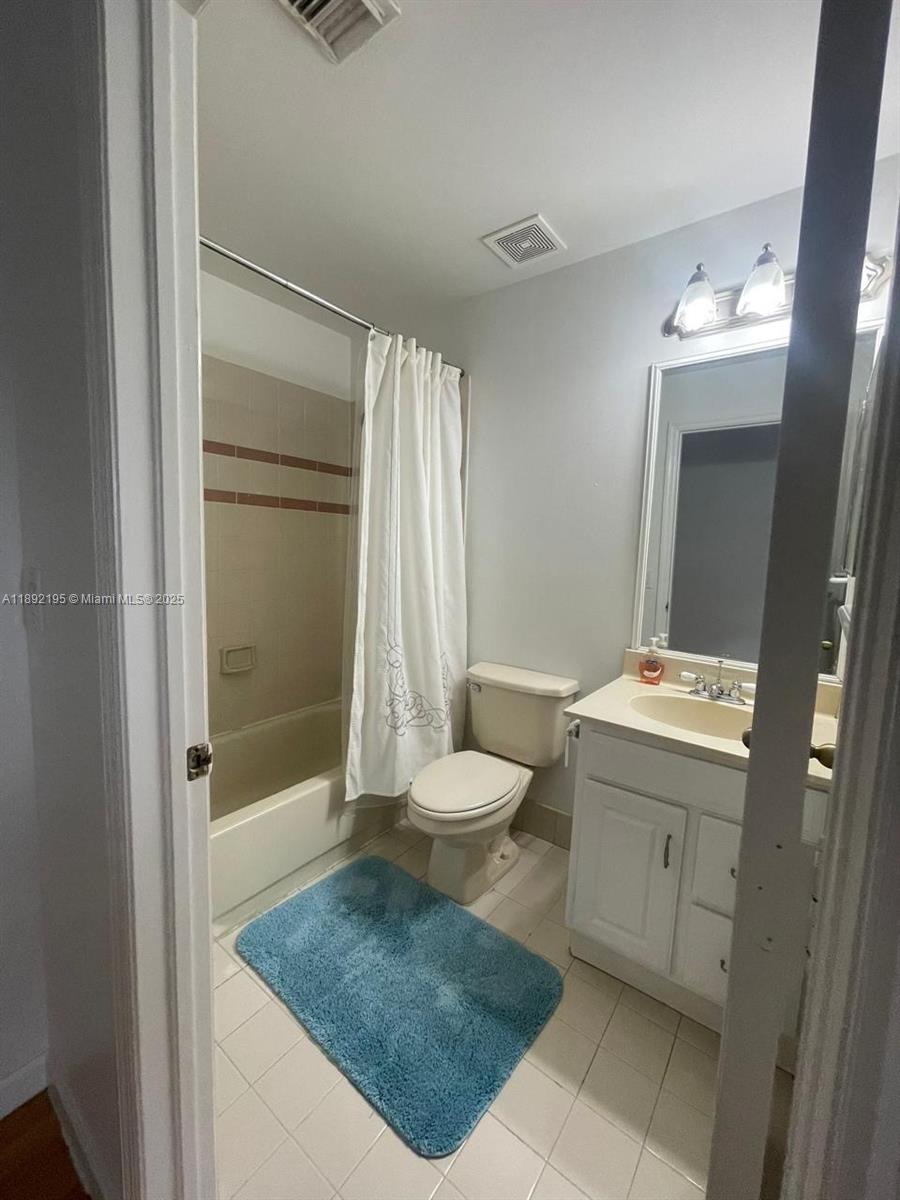 10470 Southwest 16th Street Pembroke Pines, FL 33025 - Photo 21 of 26 a bathroom with a granite countertop sink toilet and shower