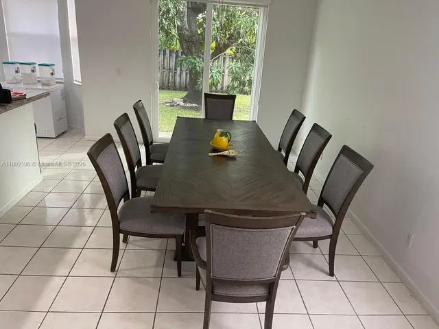 a view of a dining room with furniture and a window
