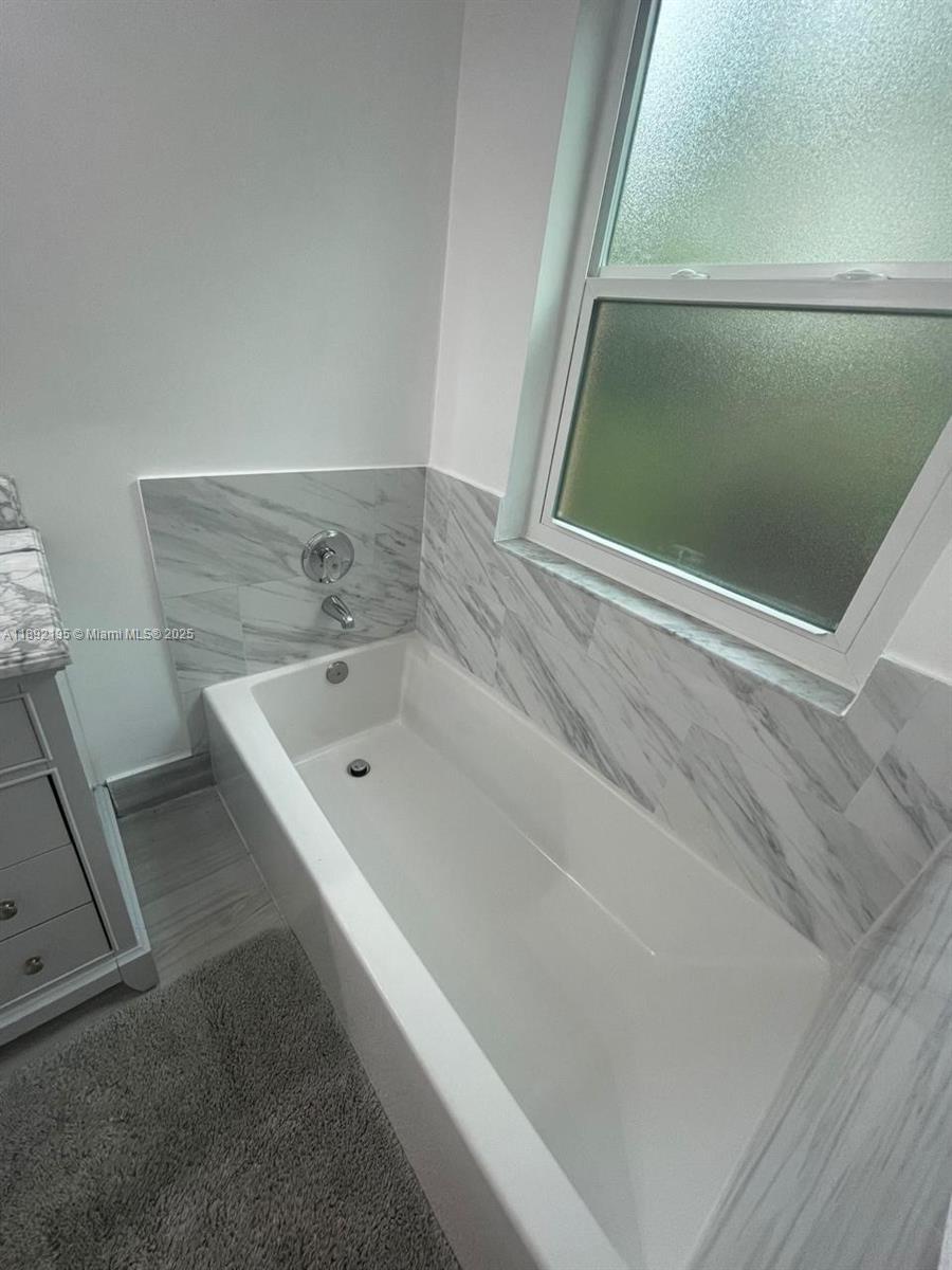 10470 Southwest 16th Street Pembroke Pines, FL 33025 - Photo 25 of 26 a bathroom with a bathtub