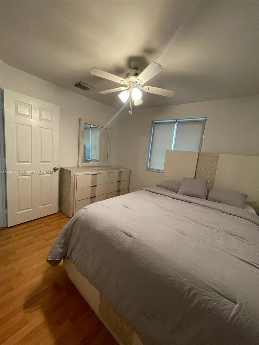 10470 Southwest 16th Street Pembroke Pines, FL 33025 - Photo 26 of 26 a bed room with a bed and a ceiling fan
