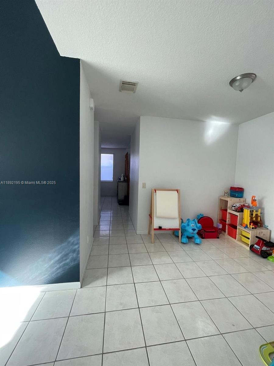 10470 Southwest 16th Street Pembroke Pines, FL 33025 - Photo 6 of 26 a view of a room with baby toys
