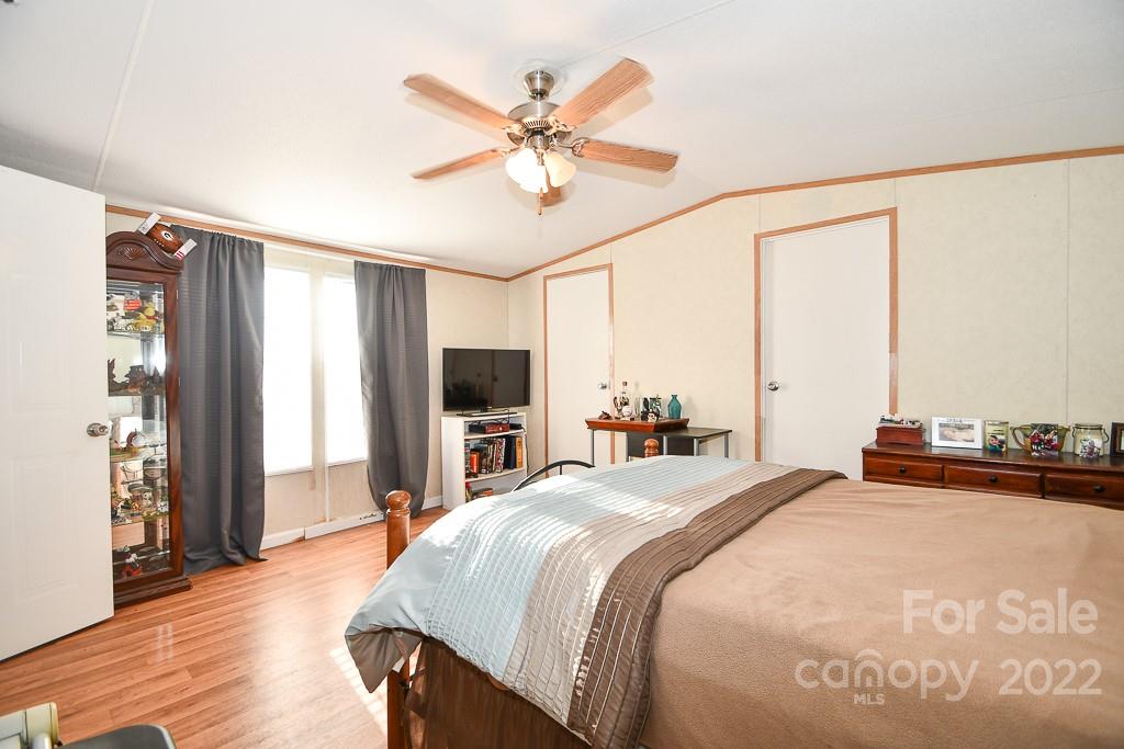 1426 Clontz Long Road Monroe, NC 28110 - Photo 10 of 12 a bedroom with a bed and a chandelier