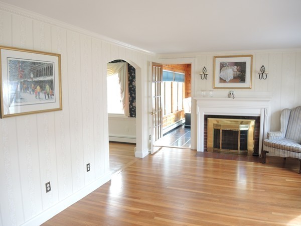 90 Elmwood Road Needham, MA 02492 - Photo 4 of 20 a view of a livingroom with wooden floor and a fireplace