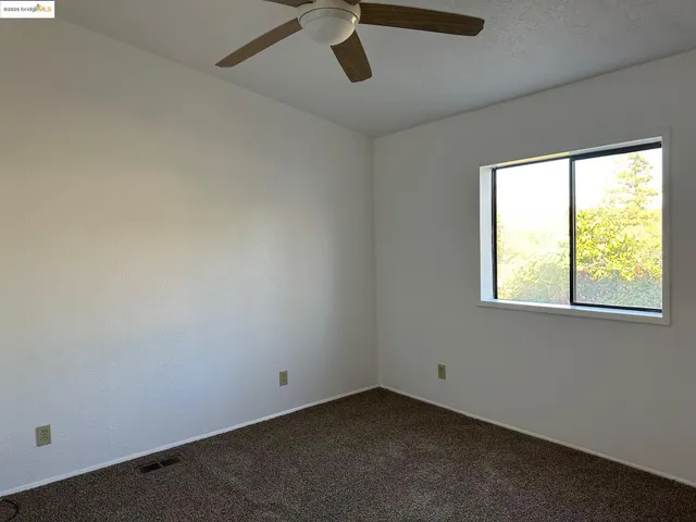 an empty room with windows and closet