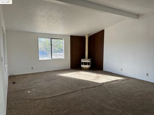 a kitchen with stainless steel appliances granite countertop a refrigerator a stove and a sink with wooden floors