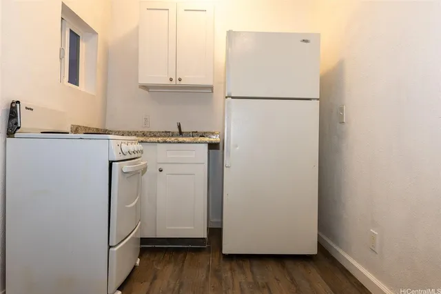 a bathroom with a granite countertop toilet a sink and shower