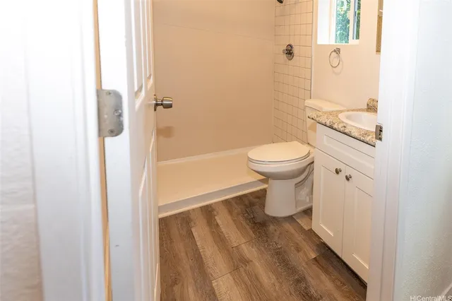 a view of a room with wooden floor closet and windows