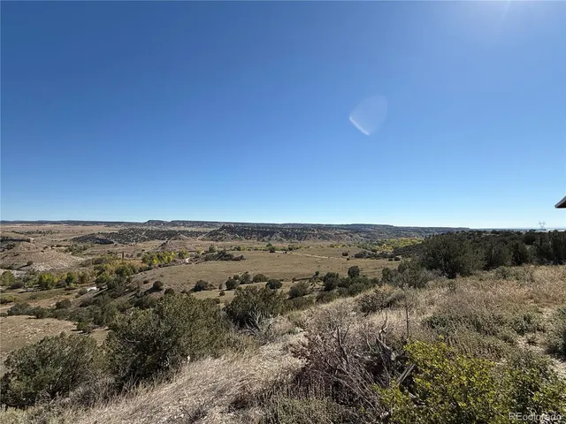 an aerial view of house with yard and mountain view