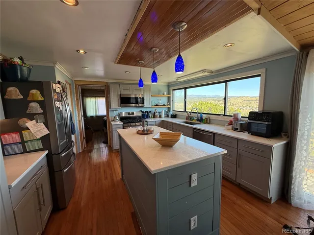 a kitchen with stainless steel appliances granite countertop a sink dishwasher stove and a refrigerator