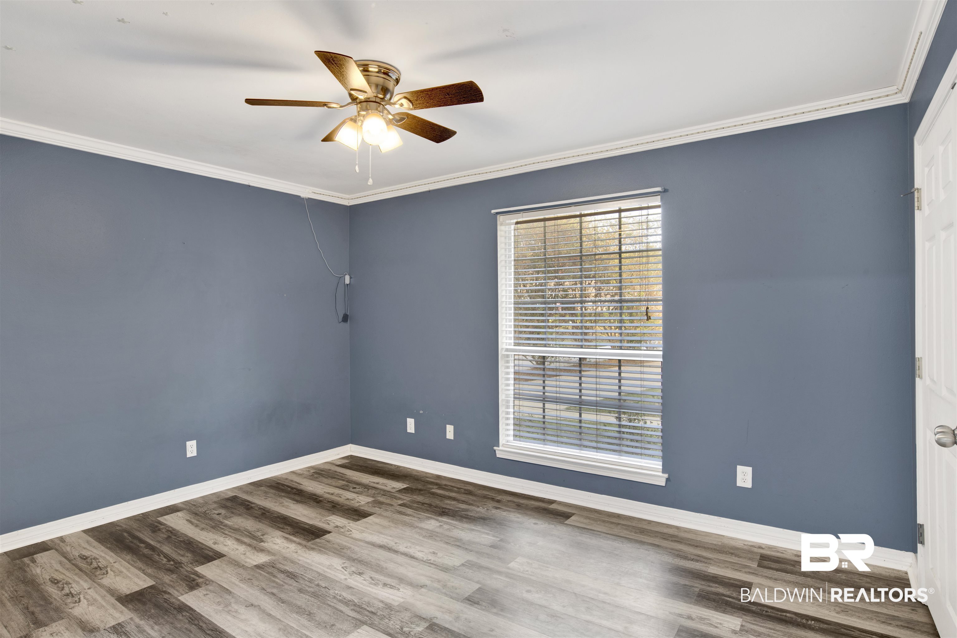 9534 Labrador Run North Mobile, AL 36695 - Photo 20 of 30 Unfurnished room featuring ornamental molding, ceiling fan, and wood finished floors