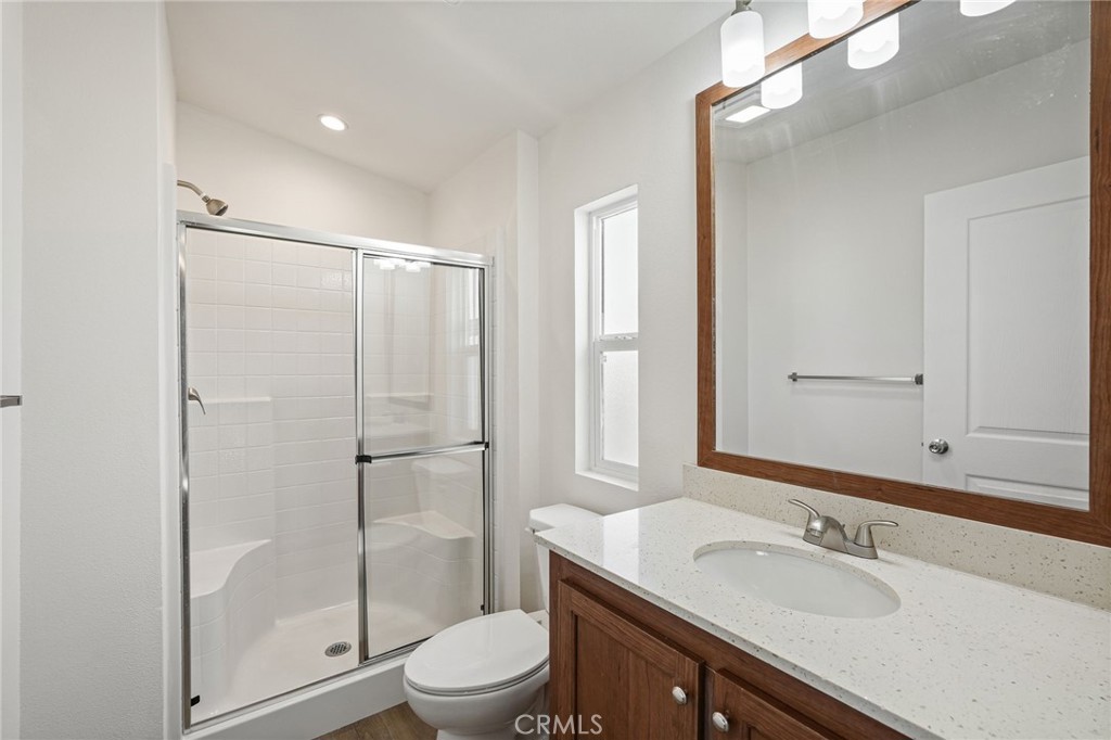 525 Palm Avenue, Unit 30 Beaumont, CA 92223 - Photo 12 of 18 a bathroom with a sink a toilet and shower