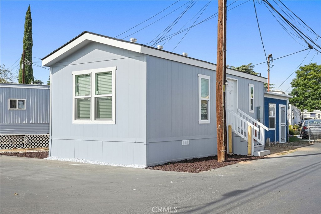 525 Palm Avenue, Unit 30 Beaumont, CA 92223 - Photo 2 of 18 a front view of a house with a road