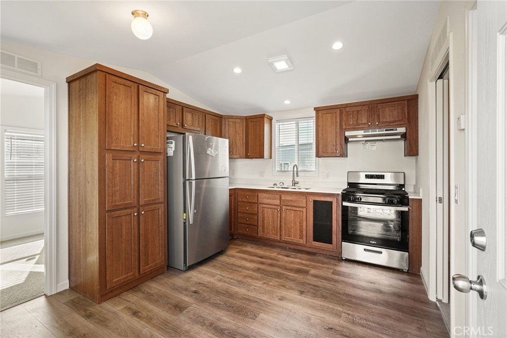 525 Palm Avenue, Unit 30 Beaumont, CA 92223 - Photo 5 of 18 a kitchen with granite countertop stainless steel appliances and refrigerator