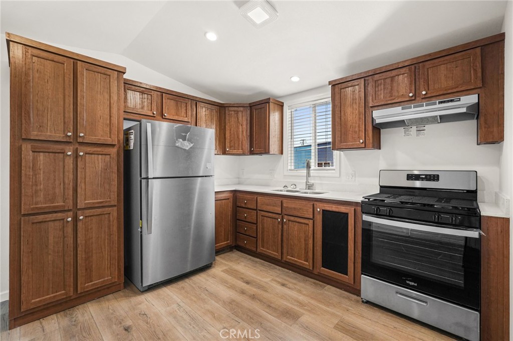 525 Palm Avenue, Unit 30 Beaumont, CA 92223 - Photo 6 of 18 a kitchen with stainless steel appliances granite countertop a refrigerator stove and sink