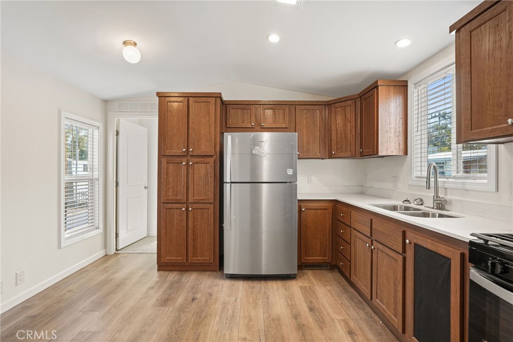 525 Palm Avenue, Unit 30 Beaumont, CA 92223 - Photo 8 of 18 a kitchen with a refrigerator sink and cabinets