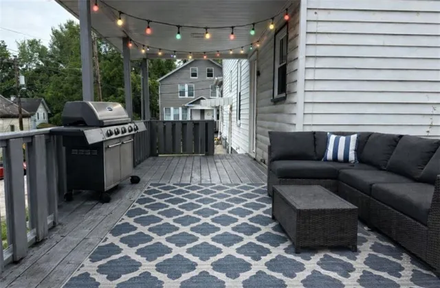 a view of balcony with wooden floor and outdoor seating