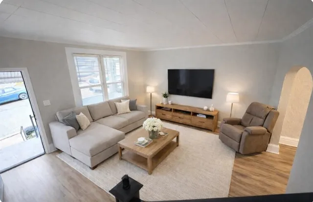 a living room with furniture and a flat screen tv