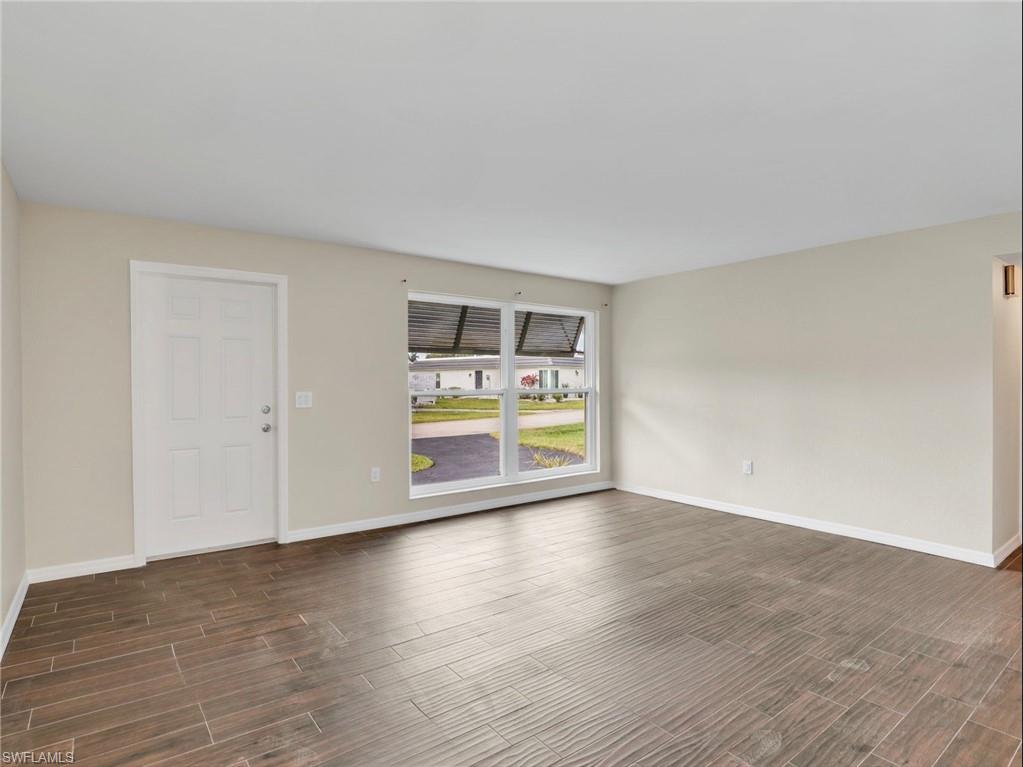 3 Knights Bridge Road, Unit A2 Naples, FL 34112 - Photo 5 of 19 Empty room featuring wood finish floors and baseboards