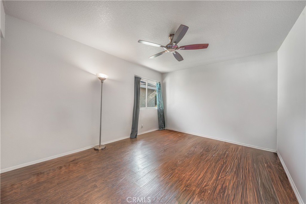 530 Conestoga Road San Dimas, CA 91773 - Photo 32 of 45 a view of an empty room with wooden floor and a ceiling fan