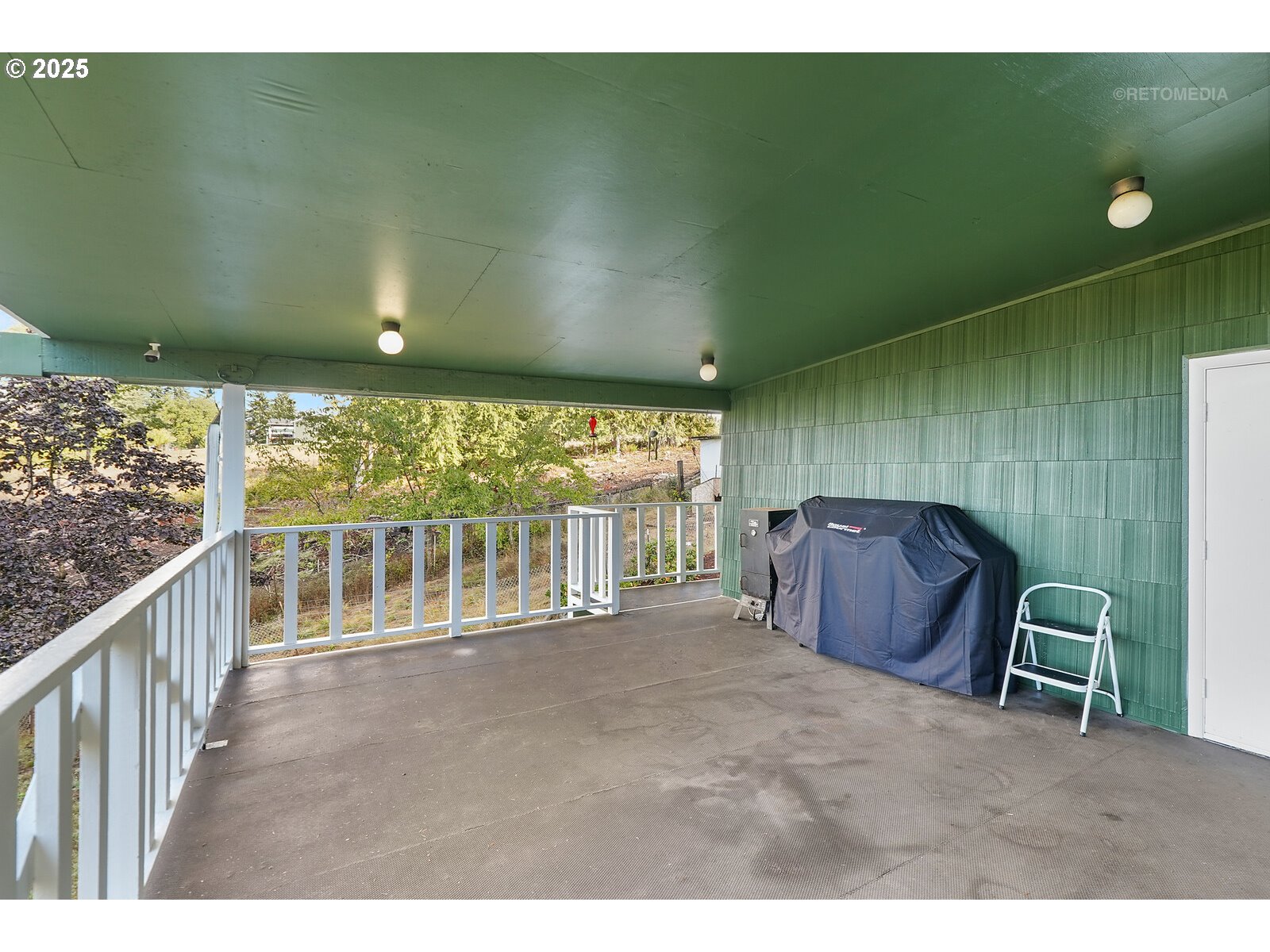 57647 Cedar Springs Drive Scappoose, OR 97056 - Photo 24 of 48 a view of a chairs and table in a balcony