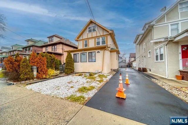 a view of a street with house in the background