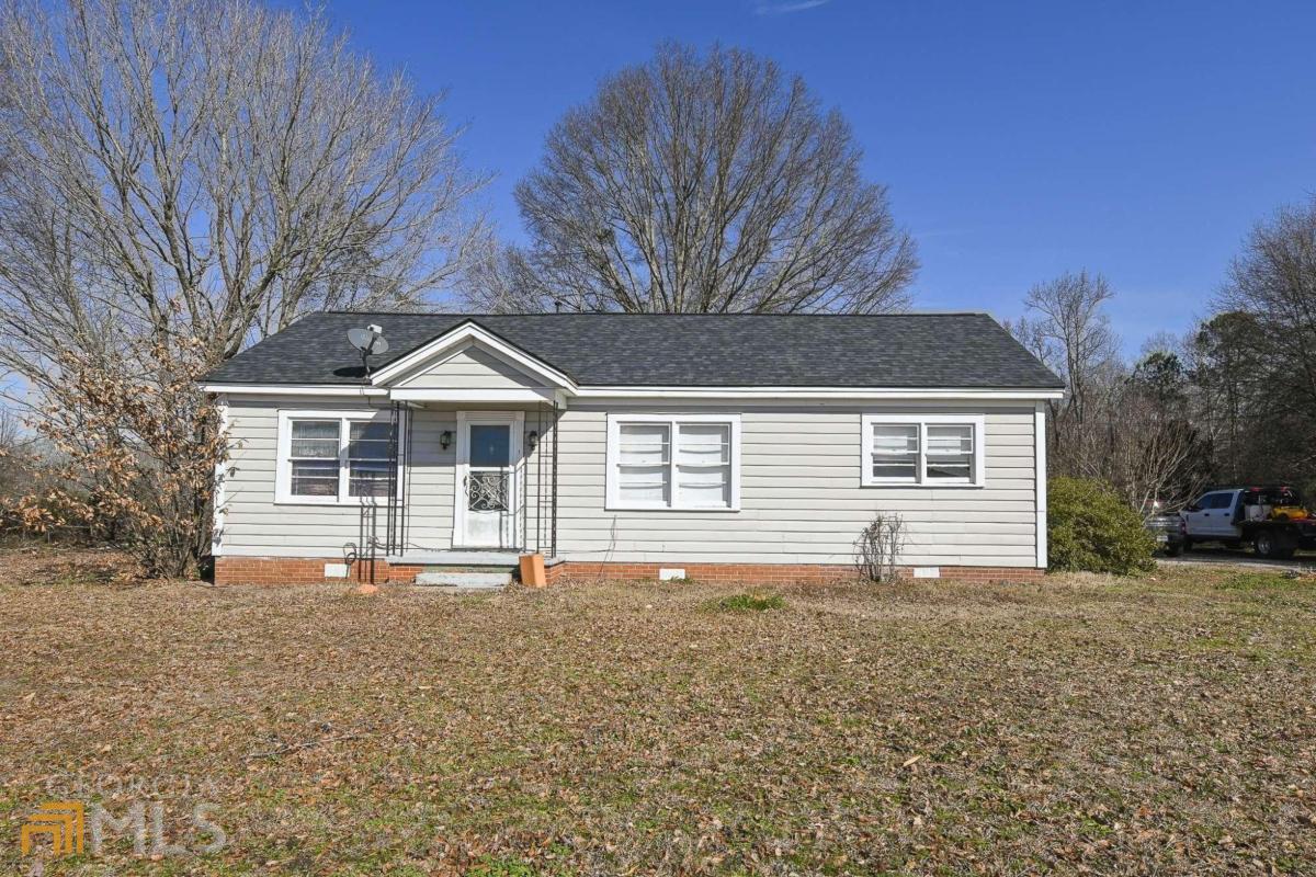3141 Highway 72 Comer, GA 30629 - Photo 1 of 1 a front view of house with yard and trees in the background