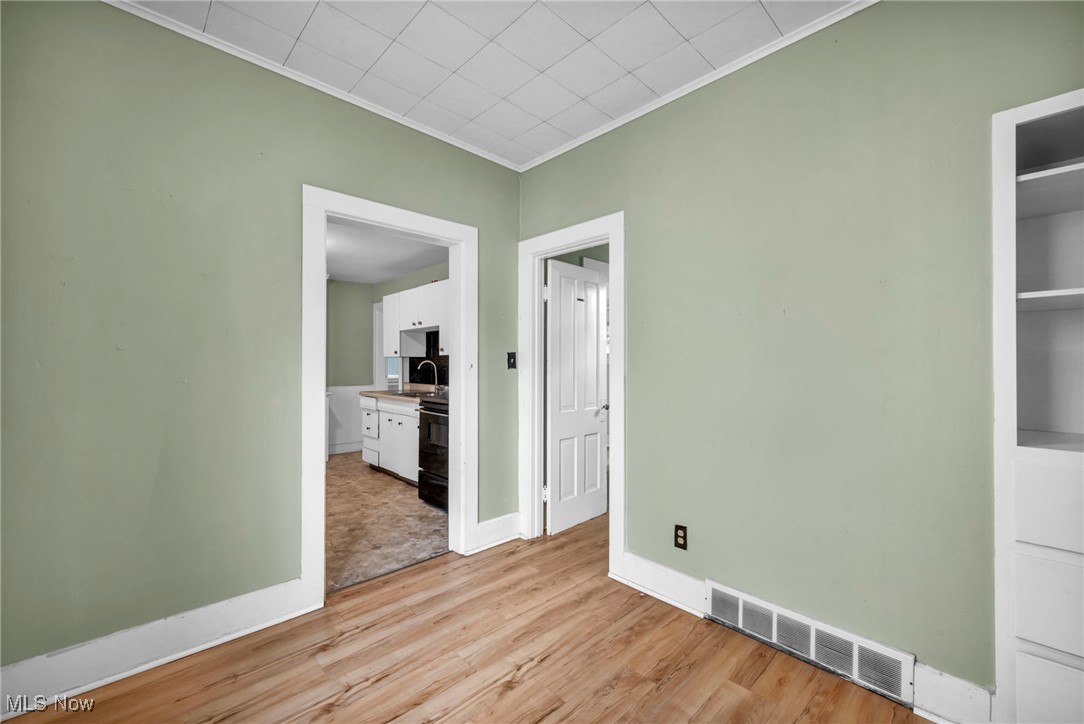 816 Perry Street Sandusky, OH 44870 - Photo 24 of 38 Spare room with crown molding and light wood-type flooring