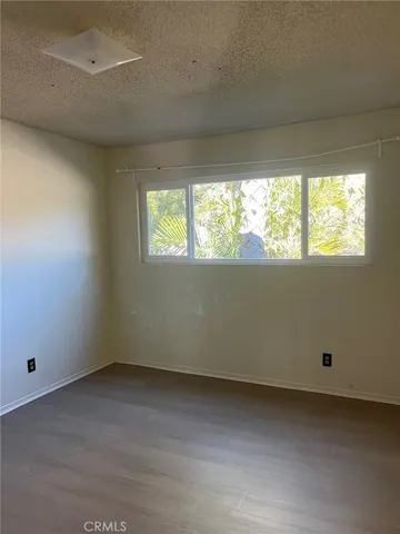 a view of balcony with wooden floor and fence