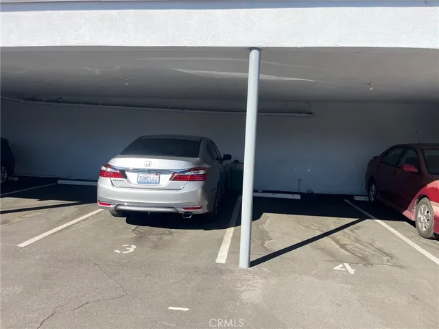 a view of a patio with table and chairs with wooden fence and plants