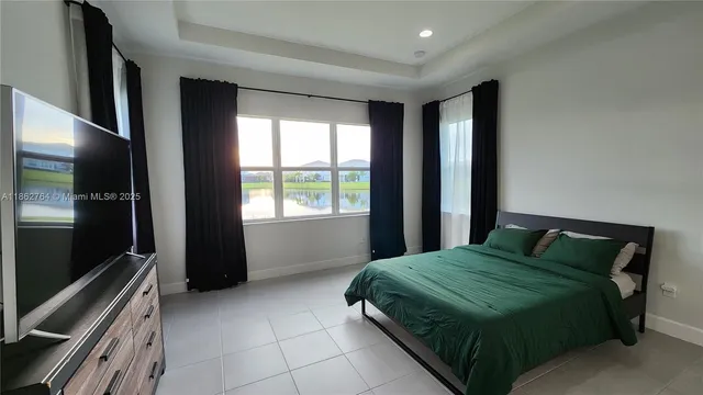 a bedroom with a bed and a television