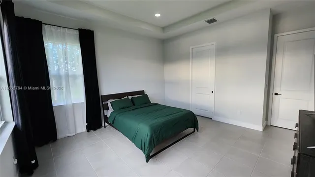 a bedroom with a bed and a mirror