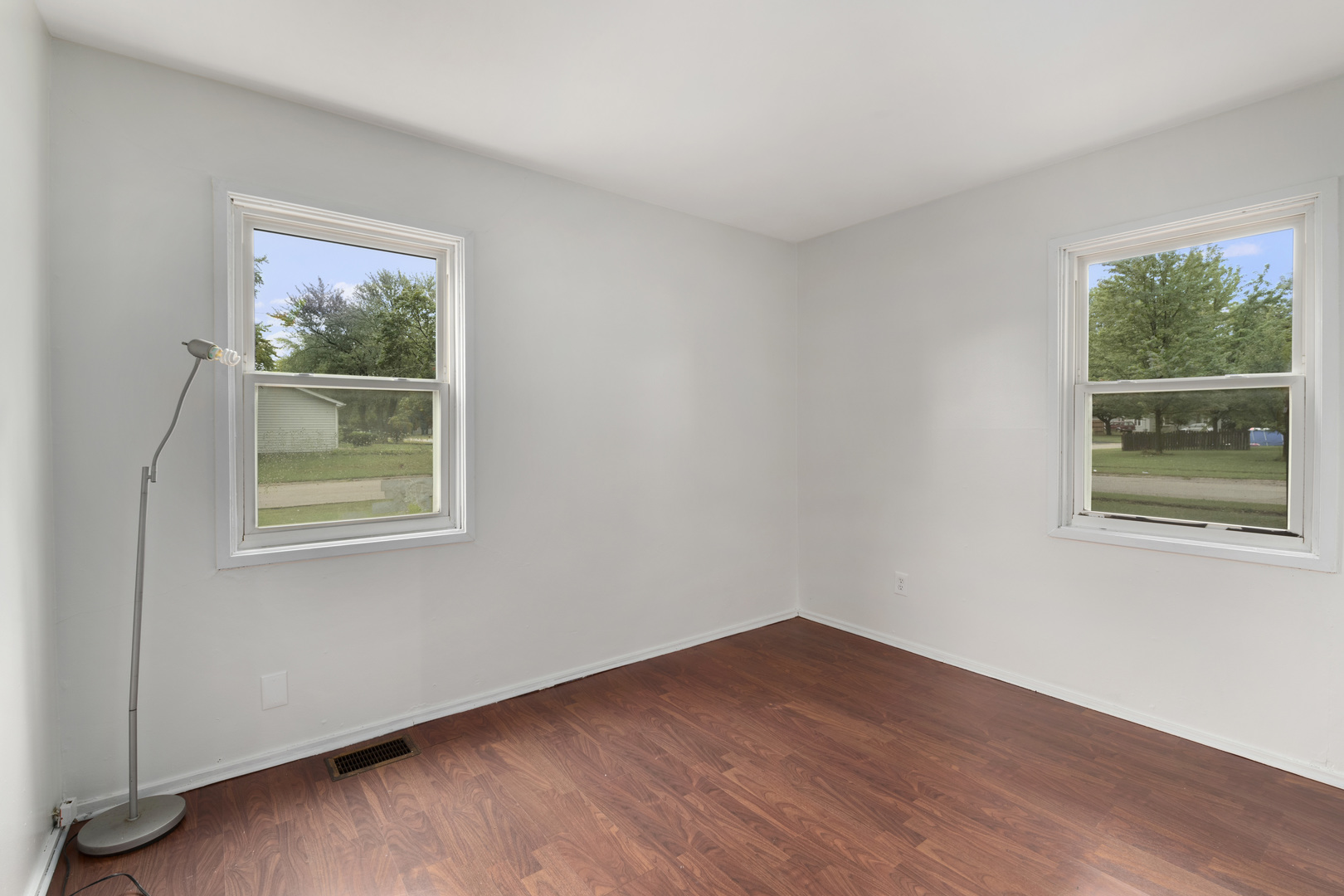 123 Luana Road Joliet, IL 60433 - Photo 13 of 16 a view of an empty room with a window and wooden floor