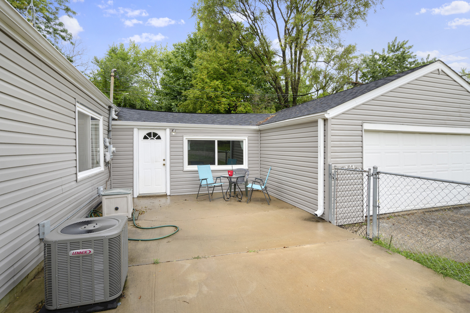 123 Luana Road Joliet, IL 60433 - Photo 3 of 16 a view of a patio with table and chairs with wooden fence and plants