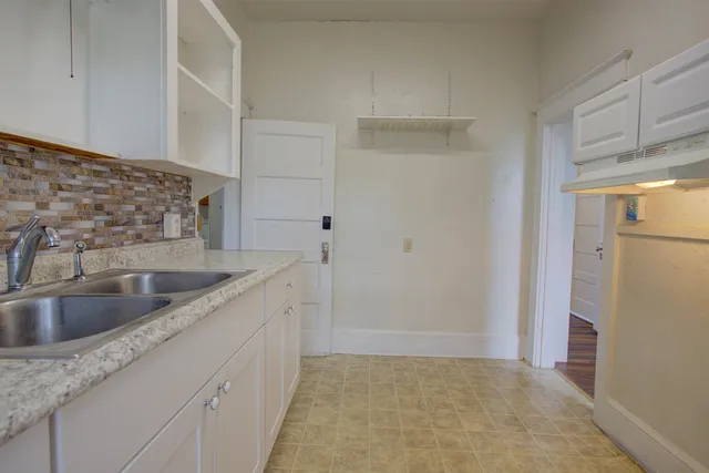 a kitchen with a sink and refrigerator