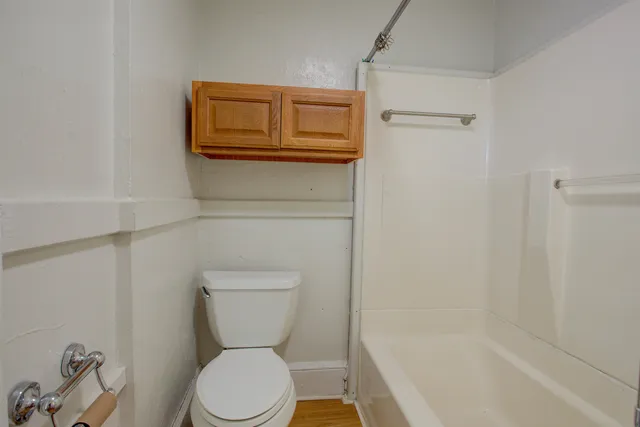 a bathroom with a toilet and a shower