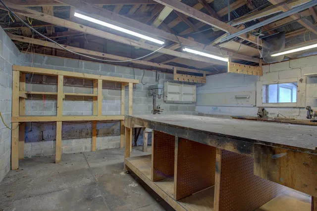 a view of a small yard in front of a house with large tree