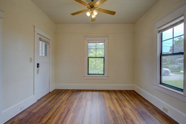 wooden floor in an empty room with a window