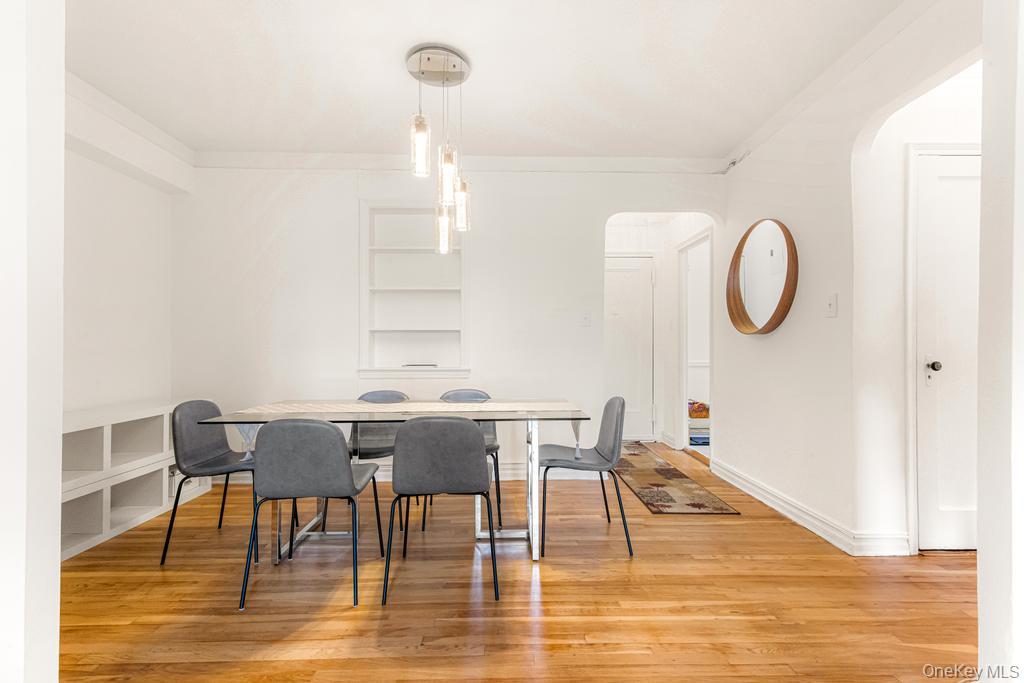 100-10 67th Road, Unit 6L Queens, NY 11375 - Photo 13 of 26 a view of a dining room with furniture and wooden floor