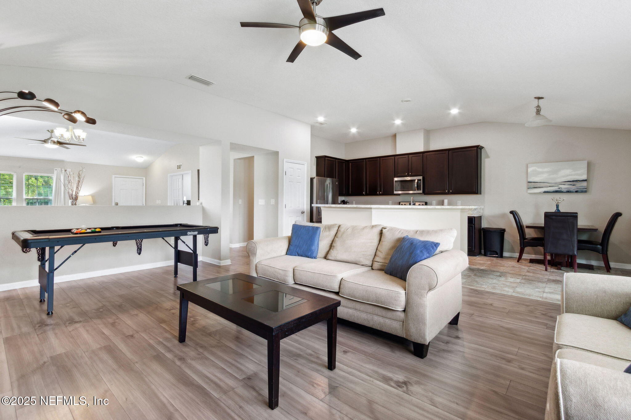 7197 Steventon Way Jacksonville, FL 32244 - Photo 13 of 58 a living room with furniture kitchen view and a wooden floor